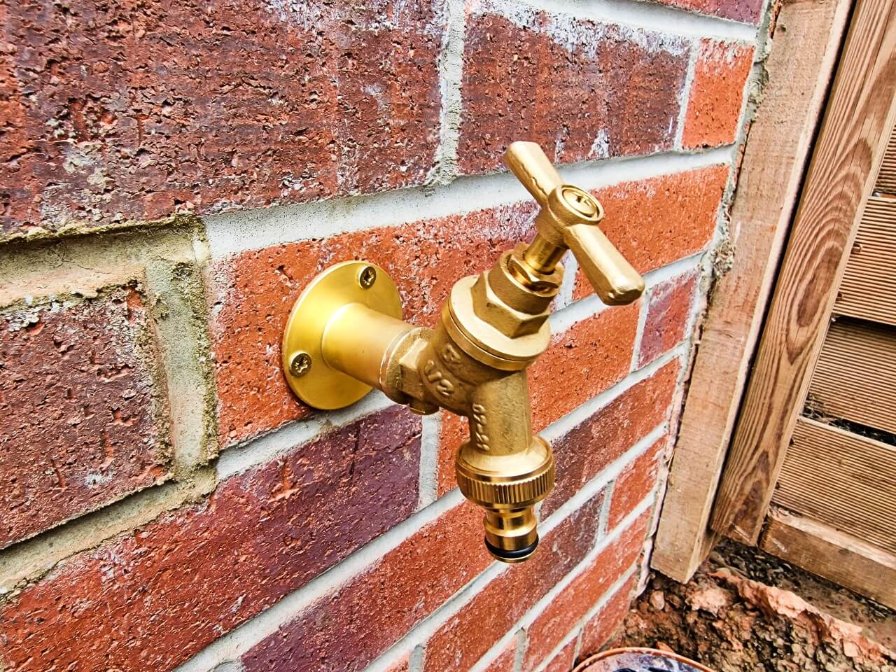 Outside tap fitted on brick wall