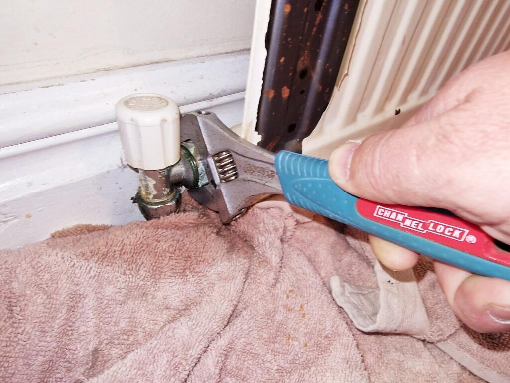 Loosening the nut on a radiator valve
