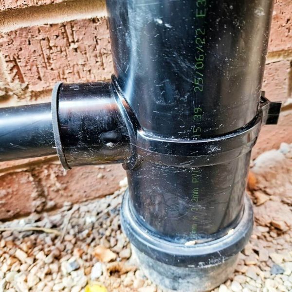 Waste pipe fitted to soil pipe