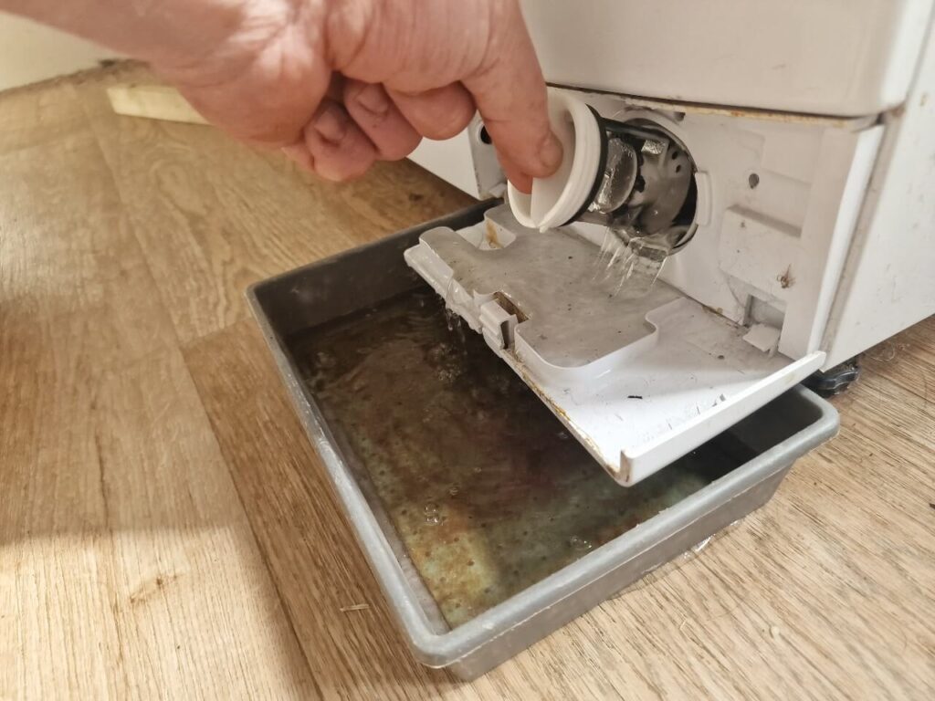 Draining water from washing machine pump filter
