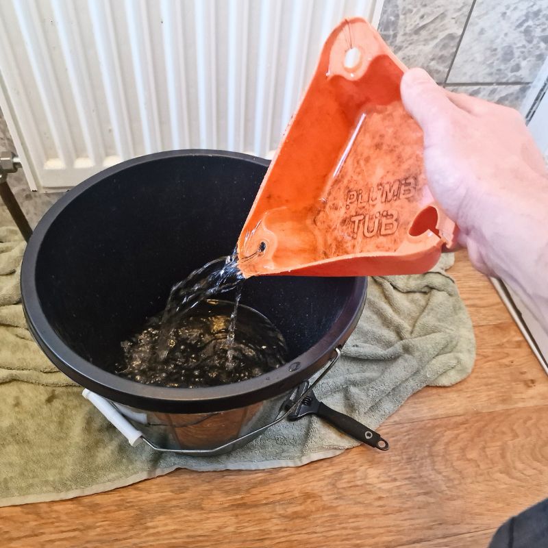 Emptying plumb tub into a bucket