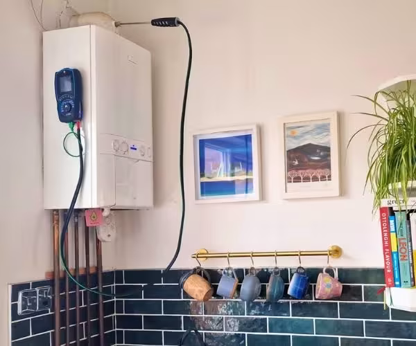 Flue gas analyser testing a boiler during a gas safety check